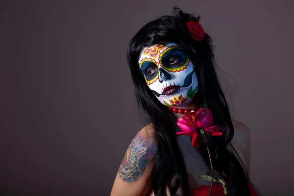 Sugar skull girl with red rose