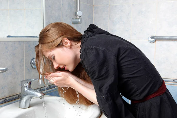 Young woman in bath wash up face