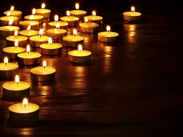 Group of candles on black background.