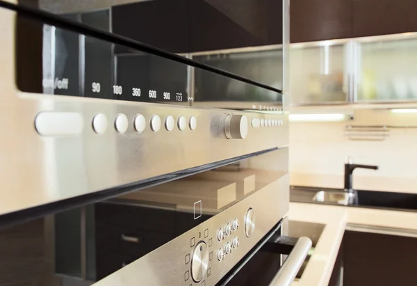 Build in microwave oven in modern kitchen interior with hardwood