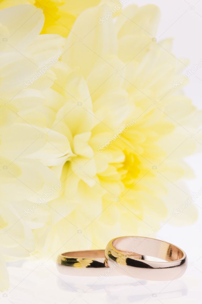 Yellow flowers and gold wedding rings