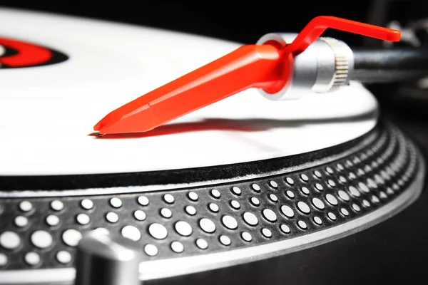 Turntable playing viyl record with music