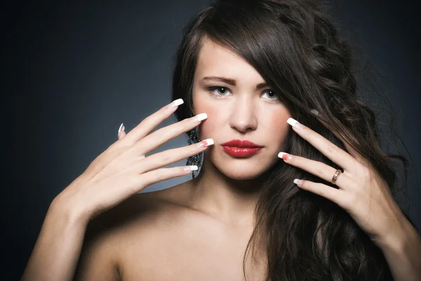 Beautiful woman with bright makeup and manicure