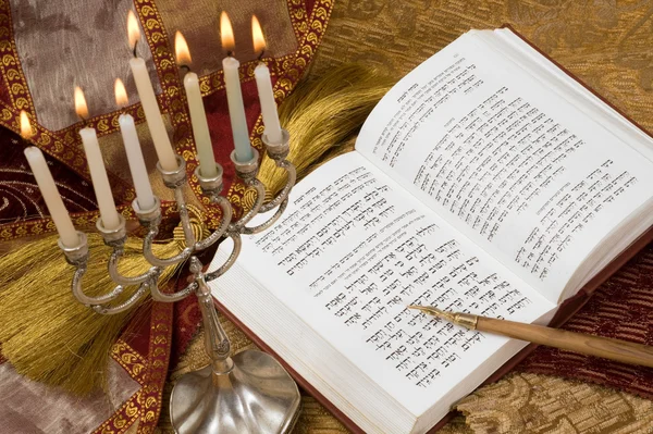 Hanukkah menorah with candles and torah