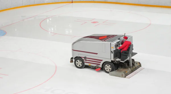 Hockey stadium with machine for resurfacing ice