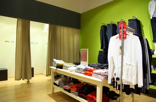 Interior of shop of clothes with fitting rooms