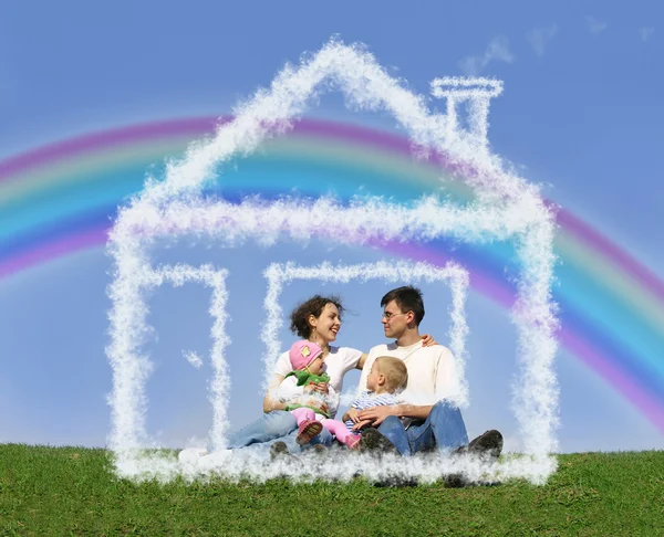 Family of four sitting in dream house and rainbow collage
