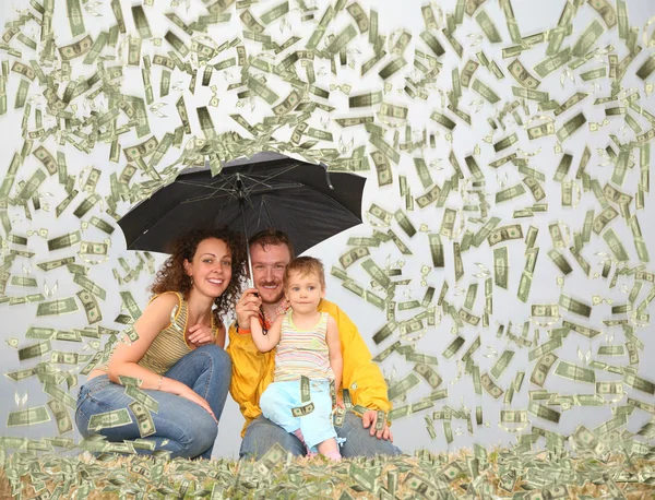 Family wih little girl with umbrella under dollar rain collage
