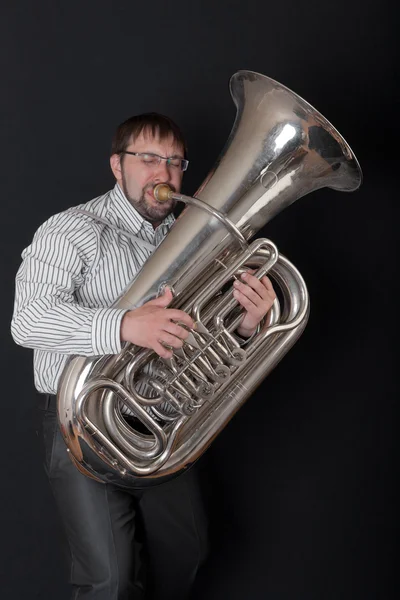 person playing tuba