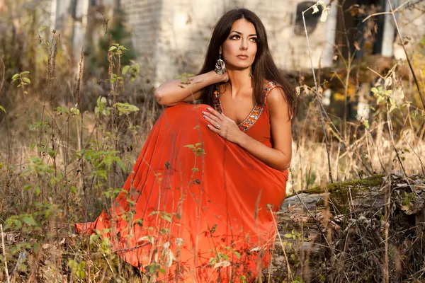 Woman in orange dress at the nature