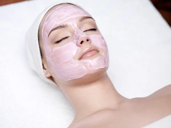 Woman with pink facial mask