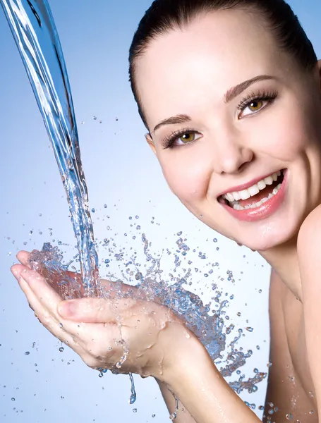 Happy woman washing face