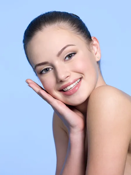 Smiling woman with healthy skin of face