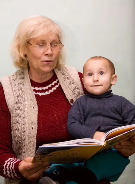 Grandmom reading to her grandson from a book