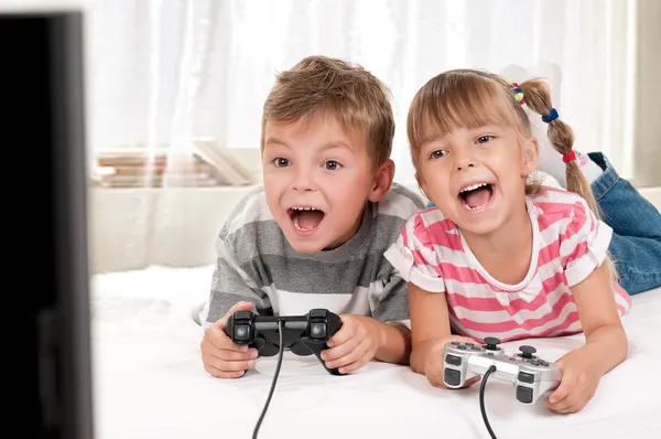 Happy girl and boy playing a video game