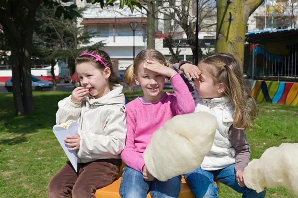 Little girls eating candy-floss
