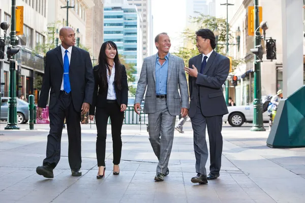 Business walking together on street