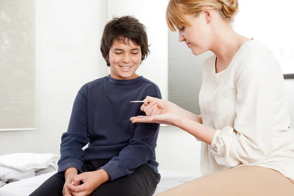 Acupuncturist With Young Male Patient