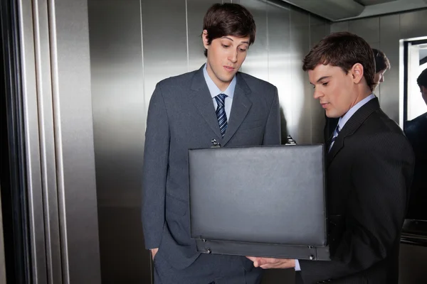 Business Men with Briefcase in Elevator