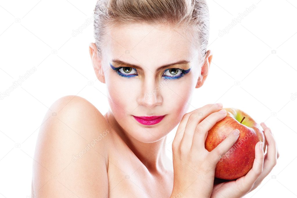 Beautiful naked young woman eating an apple. healthy food 