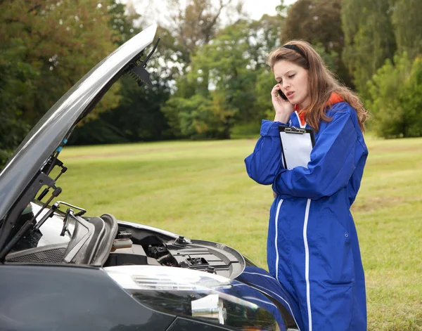 Female car mechanic with in action