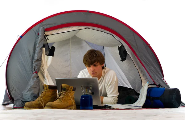 Man working with laptop in tent