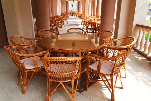 Wicker chairs in a open-air cafe