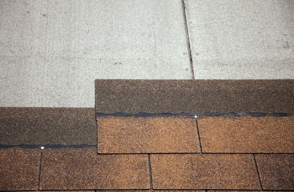 Brown asphalt roofing shingles.