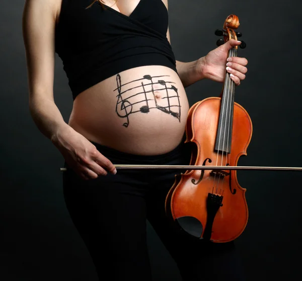 Pregnant woman with violin