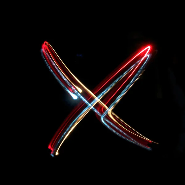 Letter X made from brightly coloured neon lights