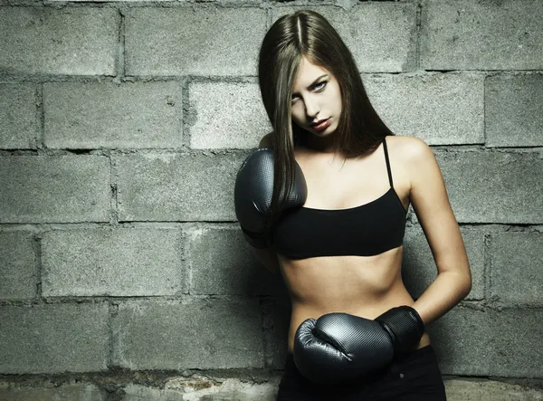 Portrait of young woman boxing