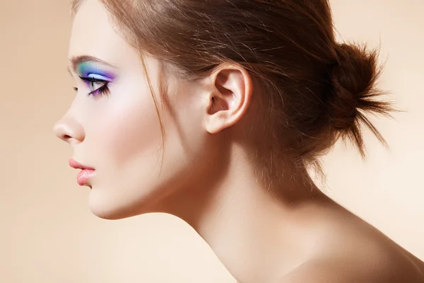 Beautiful profile view of female model face with bright fashion make-up