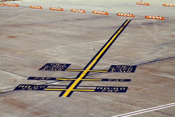 Airplane parking markings on airport tarmac yellow blue