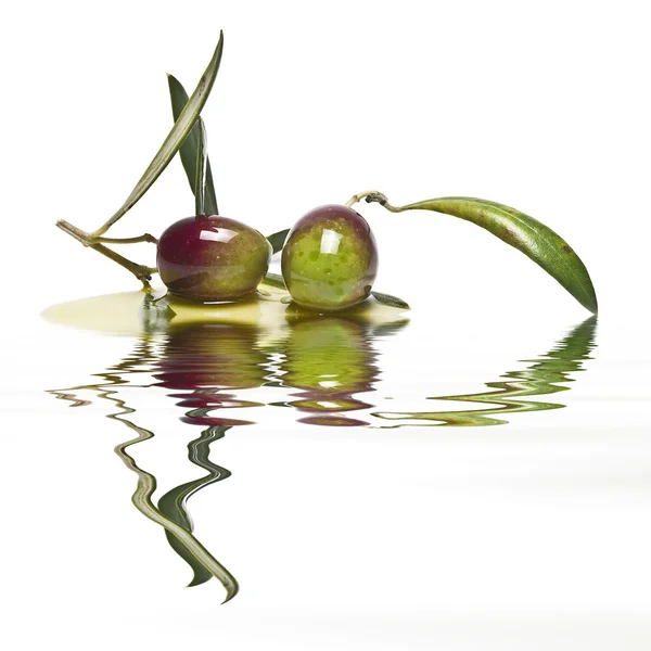 Olives reflected on water.
