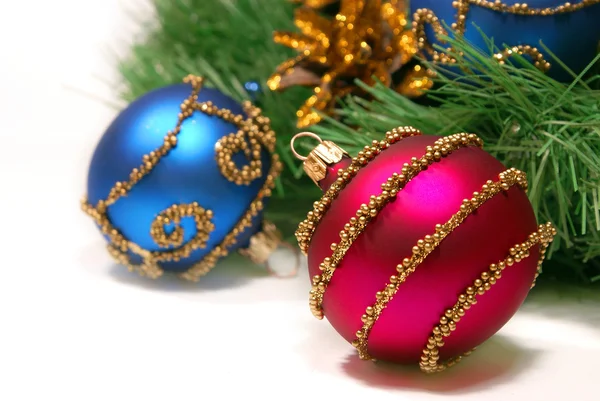 Nice Xmas decorations (red and blue spheres, golden cone and Xmas tree brunch) over white