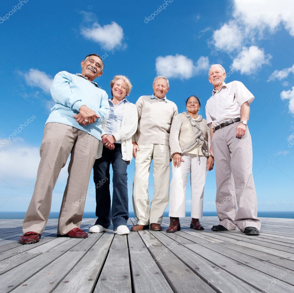 ... of mature friends standing on the wooden plank against the sky - Outdoor ... of mature friends standing on the wooden plank against the sky - Outdoor