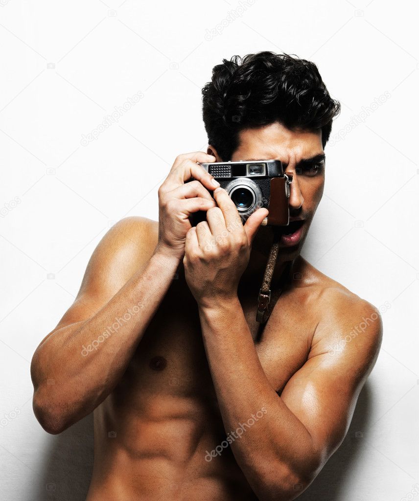 Sexy bodybuilder with nice biceps photographing you | Stock Photo