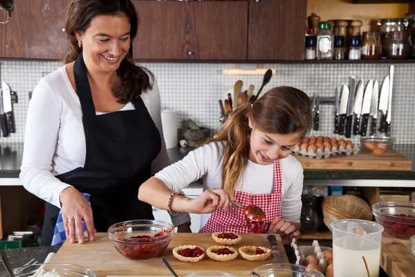Mother and daughter baking at home