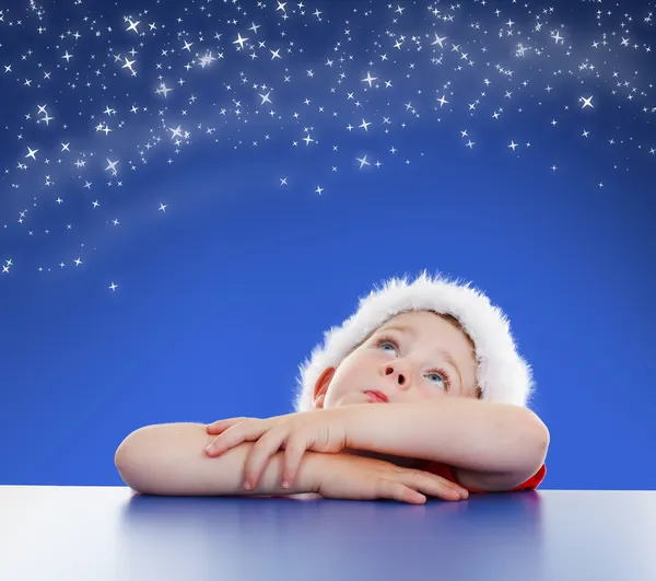 Little boy looking up to starry night sky