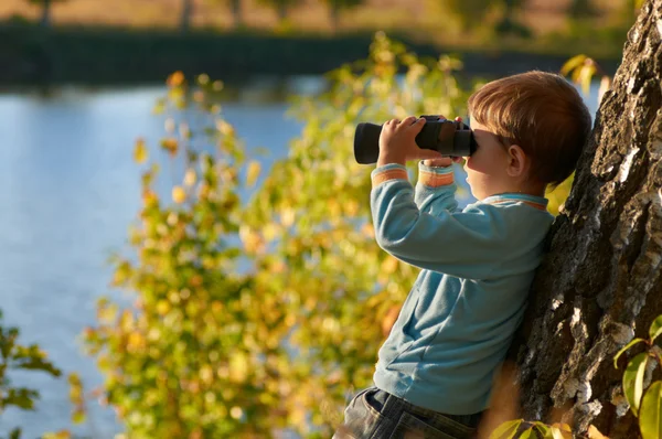 Little boy looking through binocular — Stock Photo #7463521