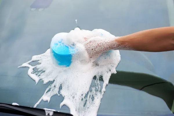 Woman washes her car