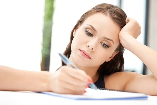Calm woman with big notepad