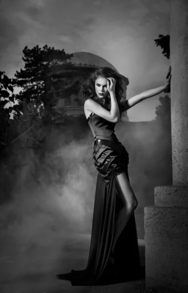 Elegant woman in black dress in black and white