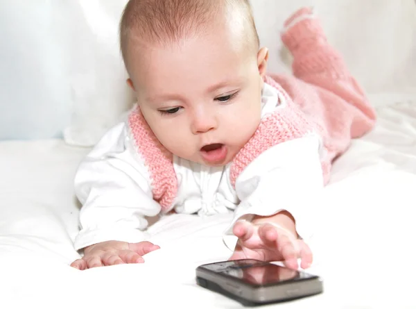 Beautiful baby girl wanting to take mobile phone to call