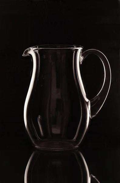 A glass jug on the mirror