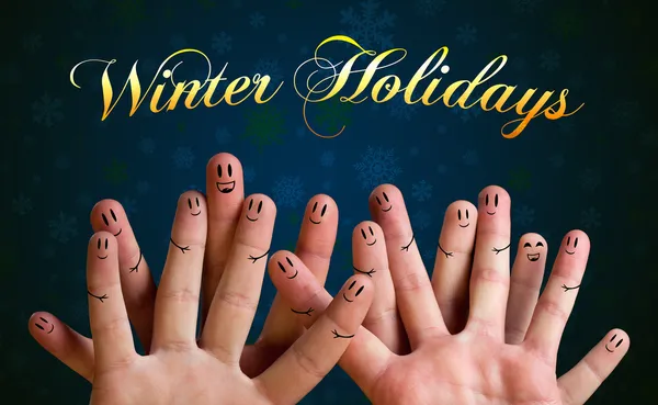 Winter holidays finger group with smiley faces on green backgrou