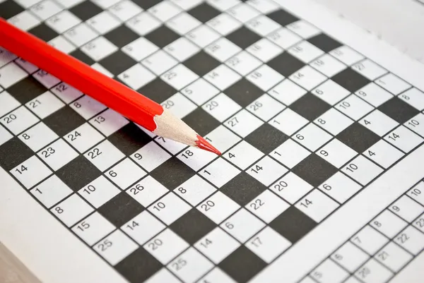 The book of crossword puzzles and red pencil.