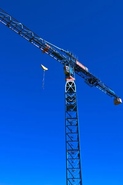 Scene with mobile crane over blue sky