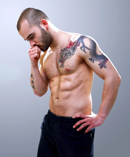 Young, masculine and fit man posing