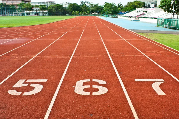 Number five six and seven on the start of a running track